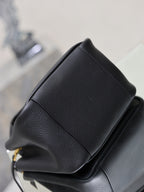YSL black leather mini tote bag corner close-up with stitched seam and paneling