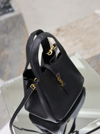 YSL black leather mini tote bag angled view with gold logo on front panel