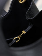 YSL black leather mini tote bag close-up of gold hardware strap and zipper pull