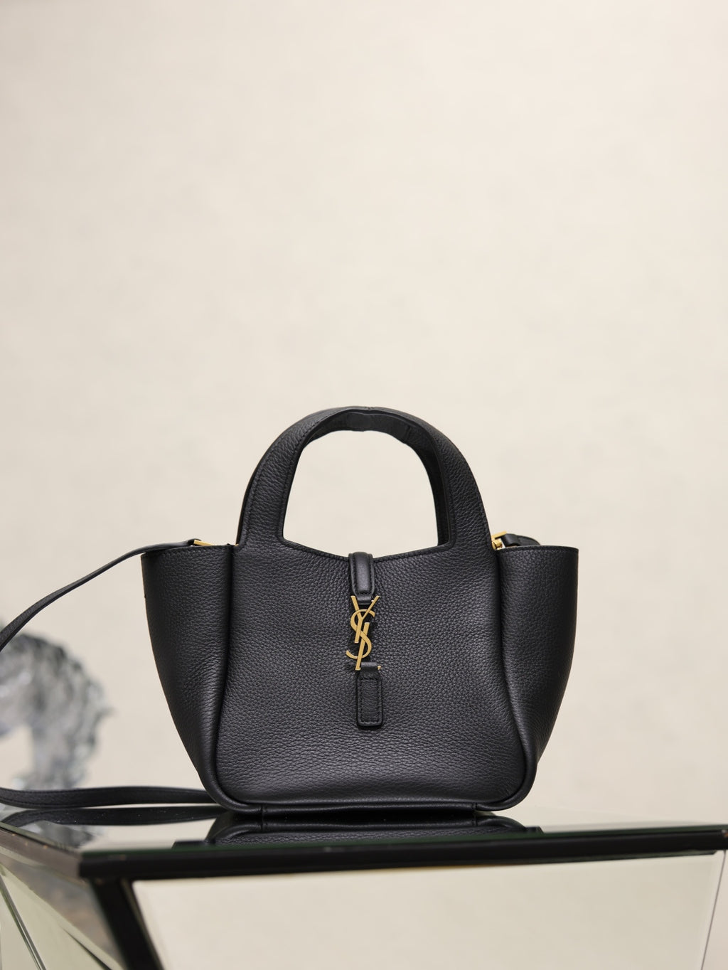 YSL black leather mini tote bag with top handles and gold logo plaque