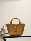 Tan suede mini tote with YSL logo charm, two handles, and shoulder strap.