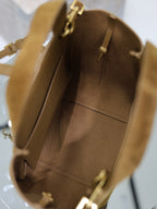 Tan suede mini tote interior with pocket seams and gold-tone hardware.