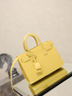 YSL mini handbag with top handles, glossy yellow, front flap detail and shoulder strap