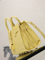 YSL mini handbag with top handles, glossy yellow, open top with accordion-style interior
