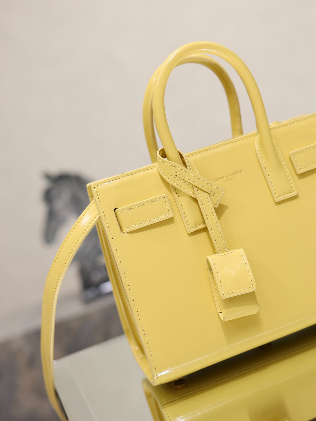 YSL mini handbag with top handles, glossy yellow, front buckle strap and side edge