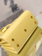 YSL mini handbag with top handles, glossy yellow, back panel with gold-tone rivets