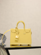YSL mini handbag with top handles, glossy yellow, front flap and buckle straps
