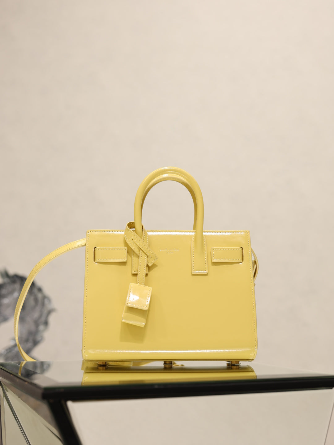YSL mini handbag with top handles, glossy yellow, front flap and buckle straps