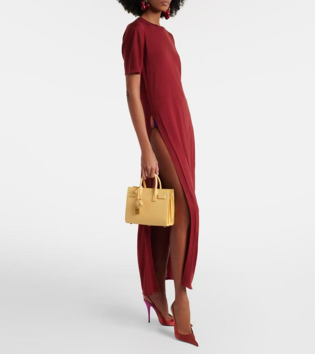 Light yellow small tote bag with top handles, worn by a model