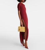 Light yellow small tote bag with top handles, worn by a model