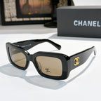 Chanel cat-eye glasses with dark frames and gold CC temple logo; tinted lenses.