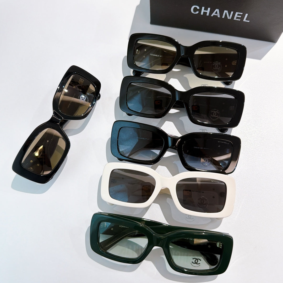 Chanel cat-eye glasses assortment with black, white, and green frames and gold CC logos.