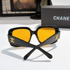 Black square sunglasses with bright yellow tinted lenses and gold CC logo.