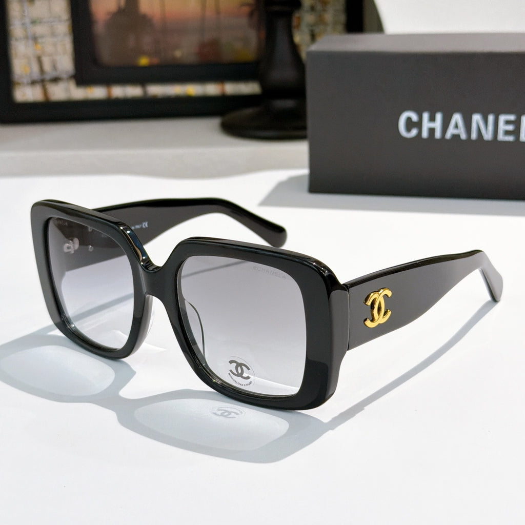 Black square sunglasses with tinted lenses and gold CC logo on temple.