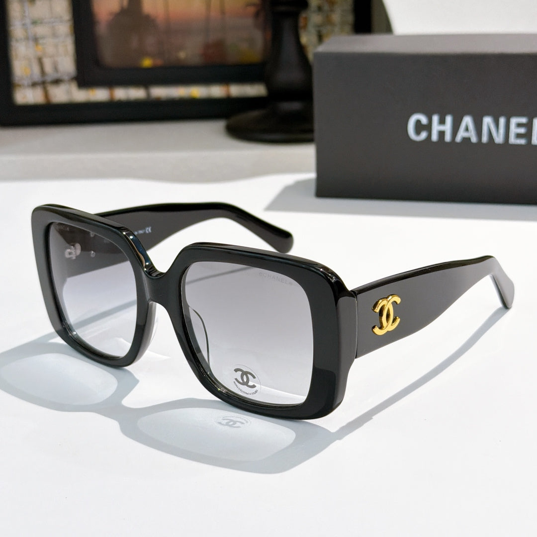 Black square sunglasses with tinted lenses and gold CC logo on temple.