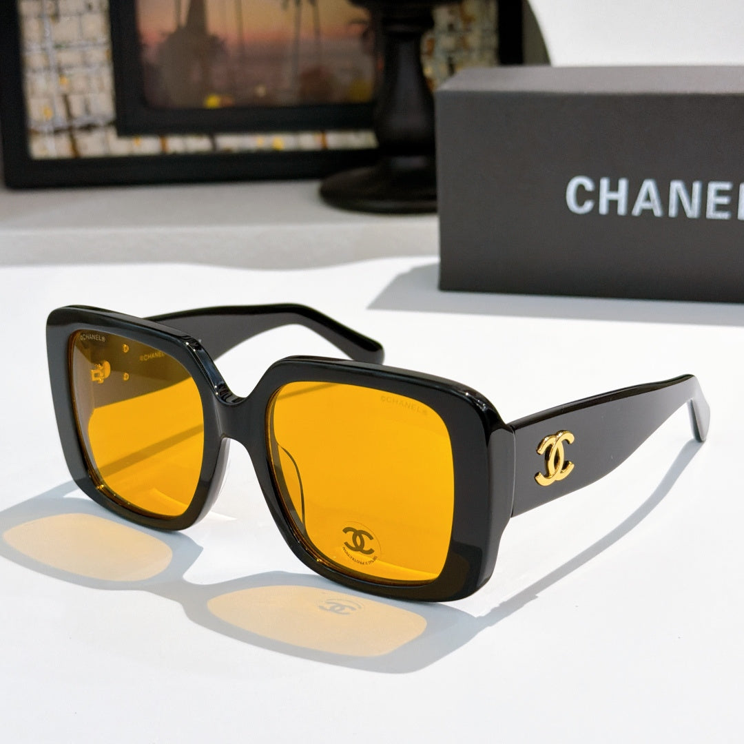 Black square sunglasses with amber mirrored lenses and gold CC logo on temple.