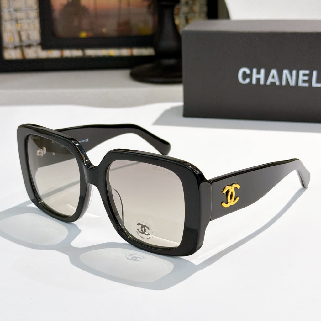 Black square sunglasses with gold CC logo on temples.