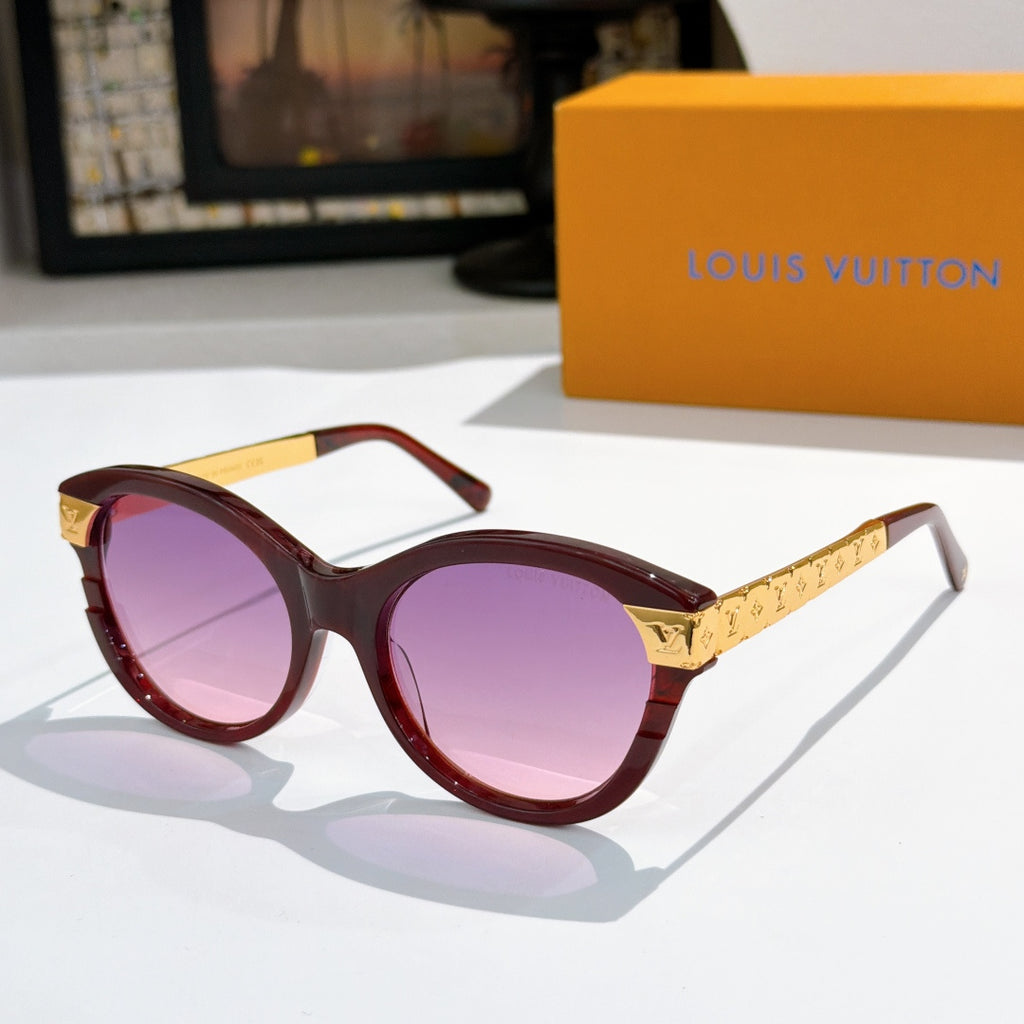 Round dark red sunglasses with purple-tinted lenses and gold logo temple arms