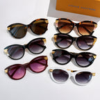 Assorted round sunglasses with gold logo temple arms and tinted lenses in dark, white, and tortoiseshell