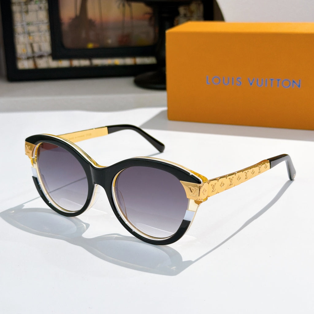 Round black sunglasses with purple-tinted lenses and gold logo temple arms