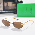 Gold-tone sunglasses with brown-tinted lenses and slim metal arms.