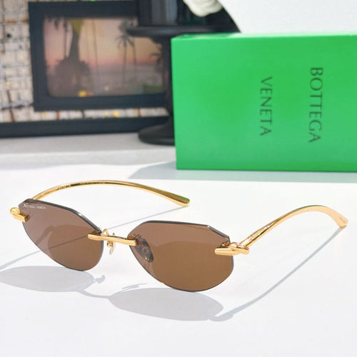 Gold-tone sunglasses with brown-tinted lenses and slim metal arms.