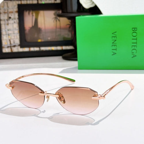 Gold-tone sunglasses with rose-brown tinted lenses and curved metal temples.