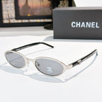 Chanel sunglasses, silver frame with blue-gray lenses and round-oval shape