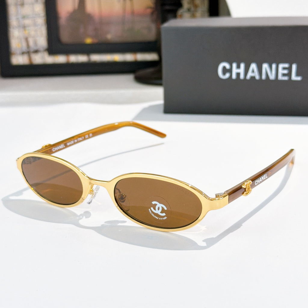 Chanel sunglasses, gold frame with dark brown lenses and rounded oval shape