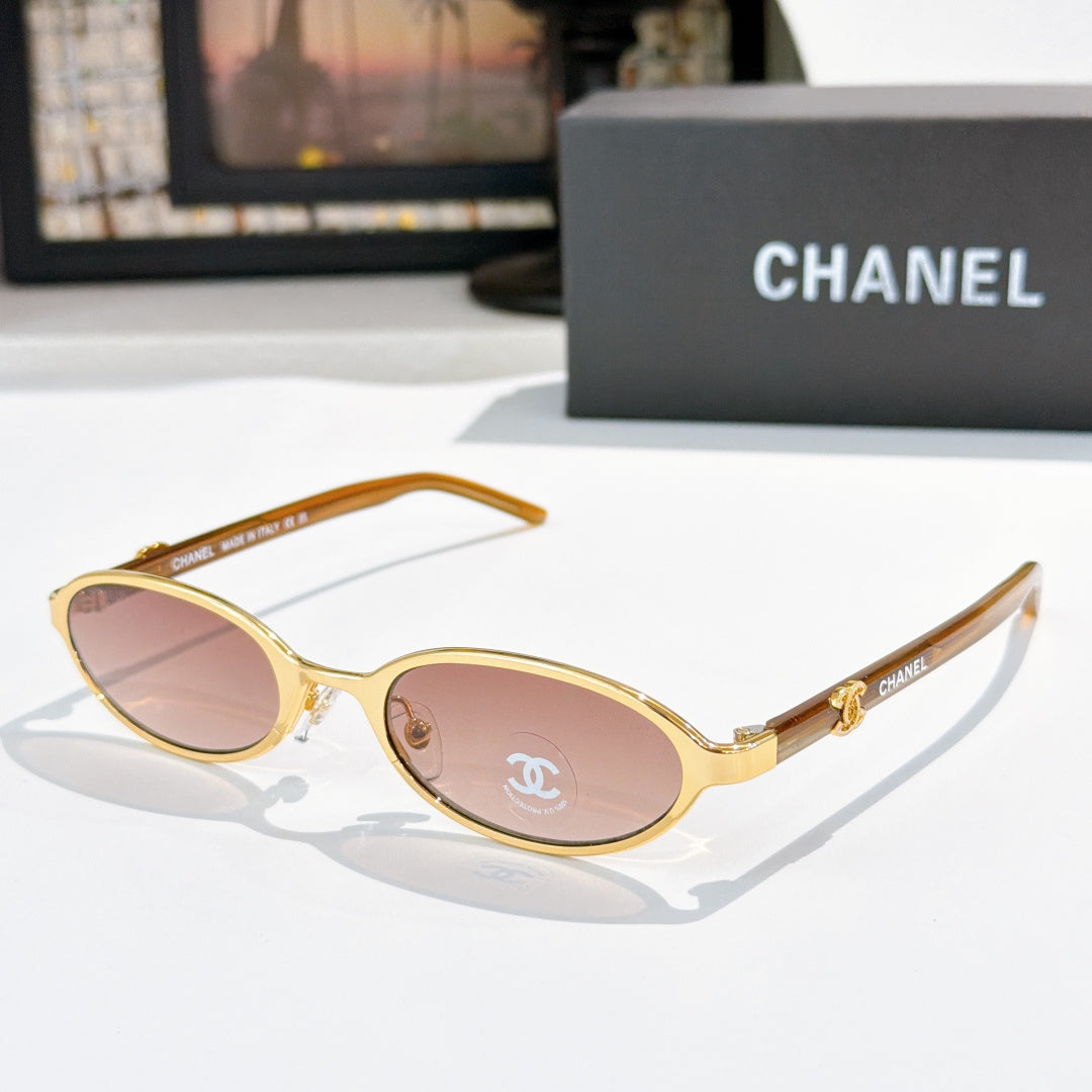 Chanel eyeglasses, gold frame with rose-tinted lenses and rounded oval shape
