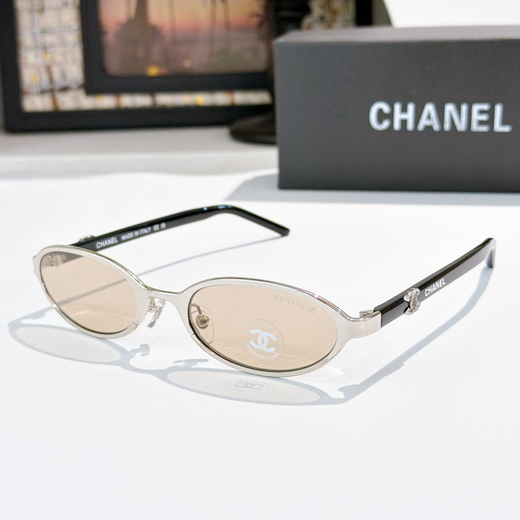 Chanel eyeglasses, silver frame with beige lenses and rounded oval shape