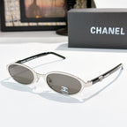 Chanel sunglasses, silver frame with gray lenses and round-oval shape