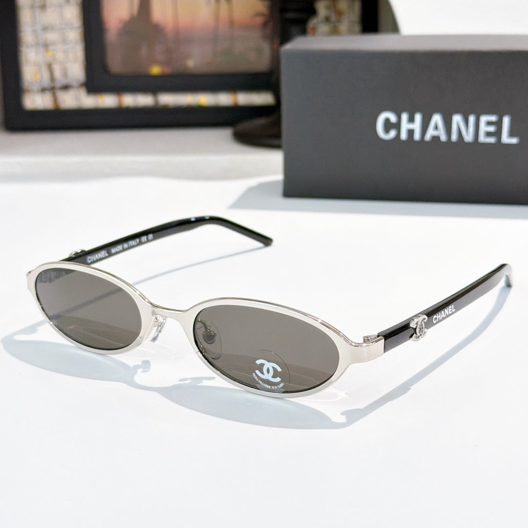 Chanel sunglasses, silver frame with gray lenses and round-oval shape
