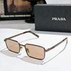 Prada sunglasses with brown tinted lenses and gold-tone rectangular frames