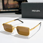 Prada sunglasses with warm amber lenses and gold-tone rectangular frames