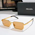 Prada sunglasses with amber lenses and gold-tone rectangular frames