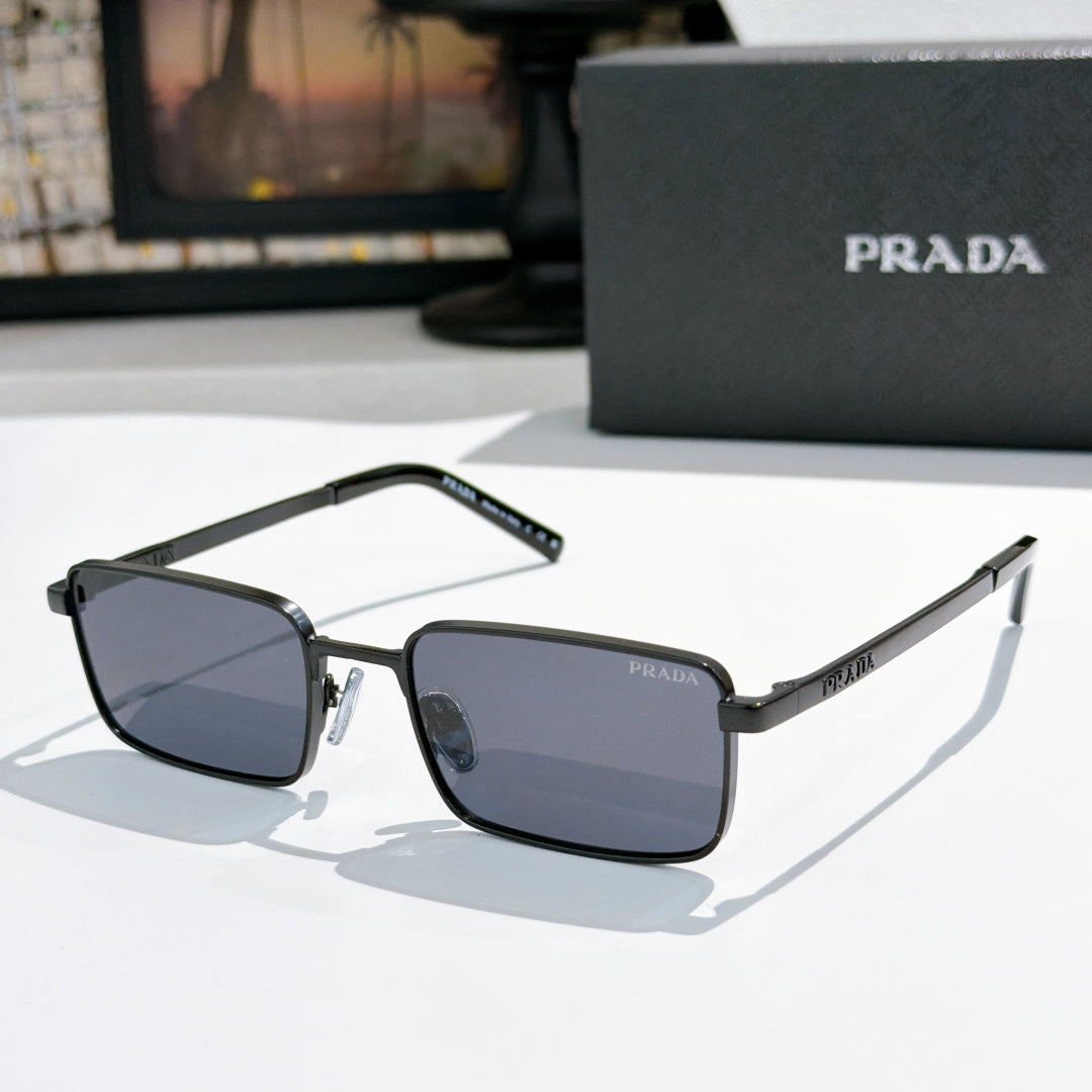 Prada sunglasses with dark blue tinted lenses and black-and-silver rectangular frames
