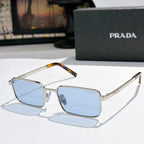 Prada sunglasses with light blue gradient lenses and silver-tone rectangular frames
