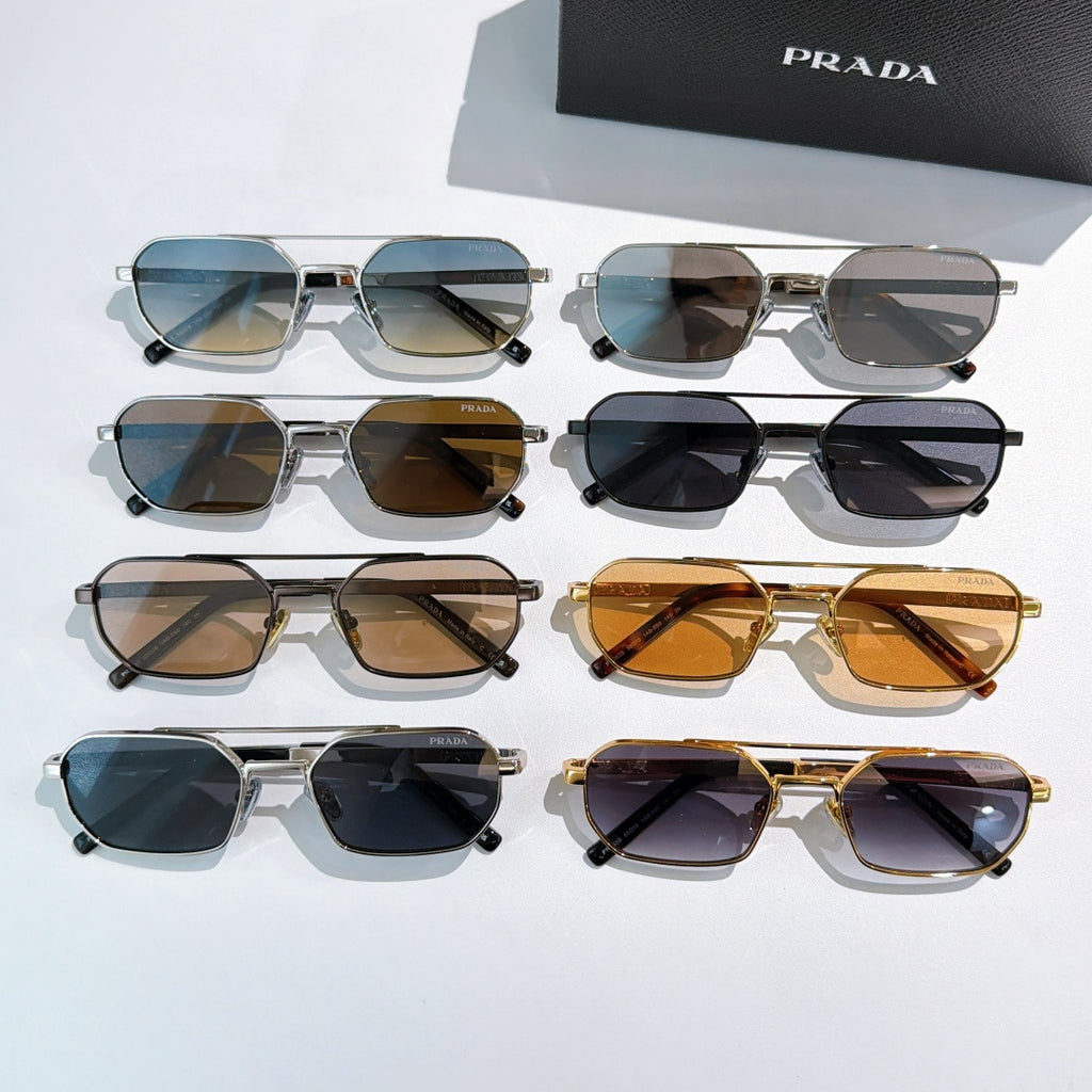 Prada sunglasses assortment with mixed frames and tinted lenses, laid out flat
