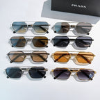 Prada sunglasses assortment with mixed frames and tinted lenses, laid out flat