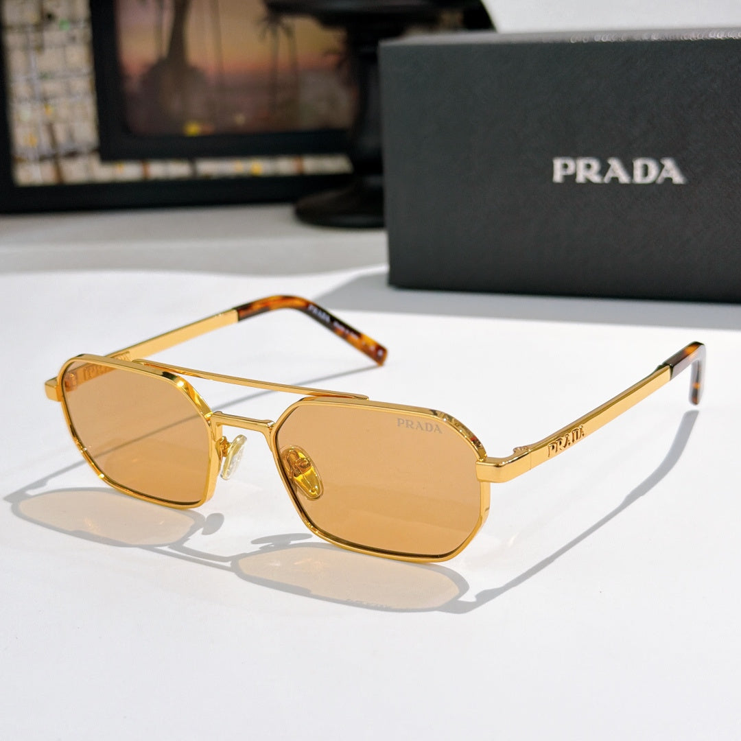 Prada sunglasses with gold frame, amber lenses, tortoise temple tips