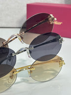 Stacked round sunglasses with dark and light lenses and gold-tone metal frames