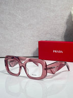 Prada eyeglasses with pink frames and clear lenses, dark temple accents