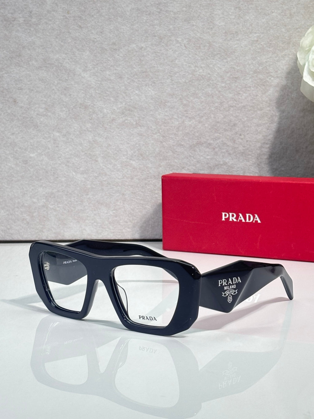 Prada dark navy rectangular eyeglasses with clear lenses and logo temples