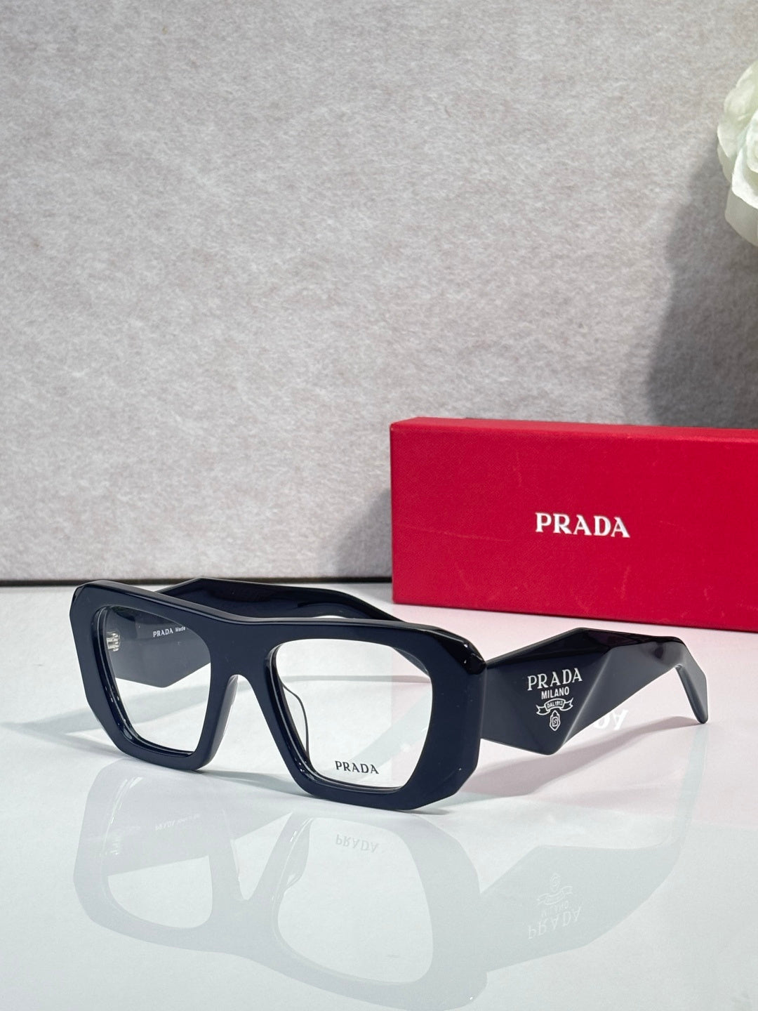 Prada dark navy rectangular eyeglasses with clear lenses and logo temples
