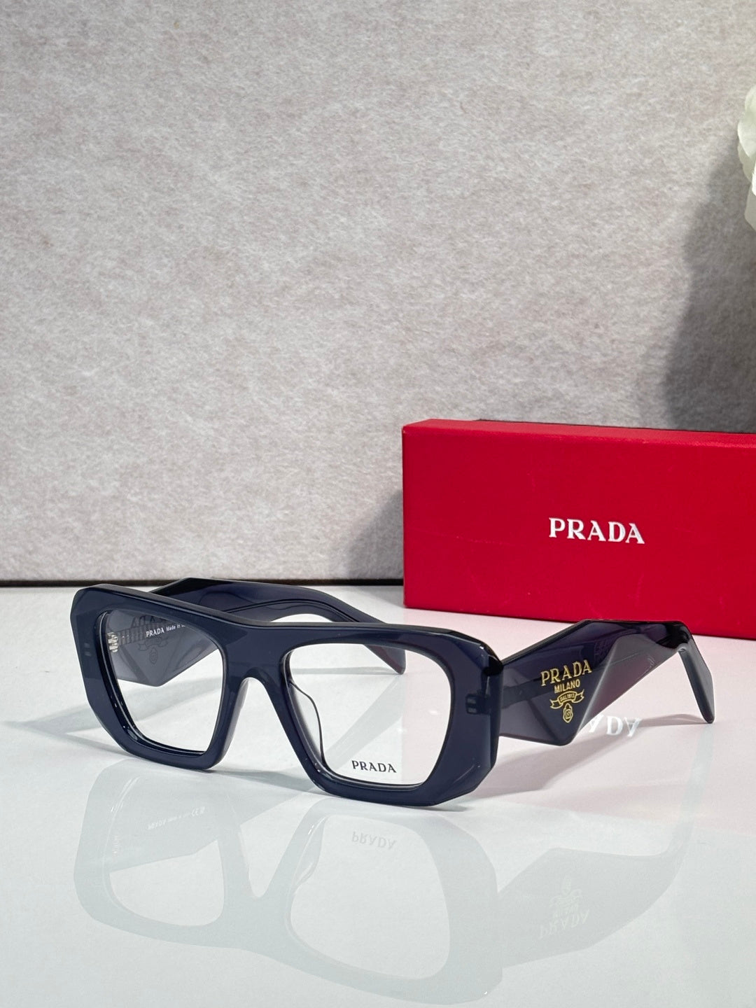 Prada black rectangular eyeglasses with clear lenses and logo-marked temples