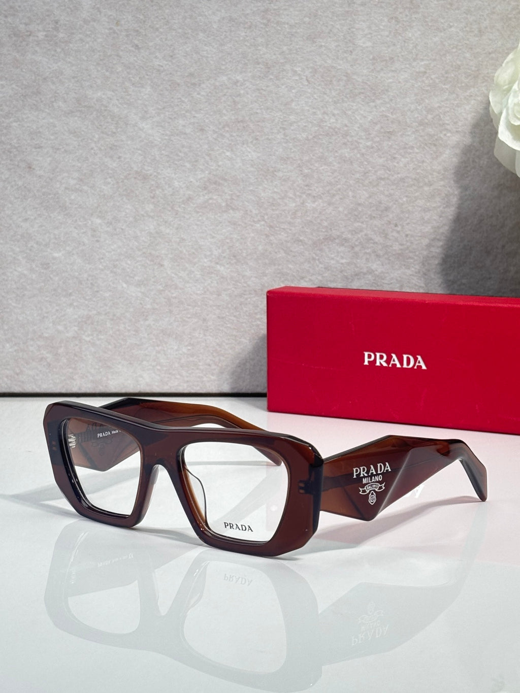 Prada dark brown rectangular eyeglasses with clear lenses and tortoise accents