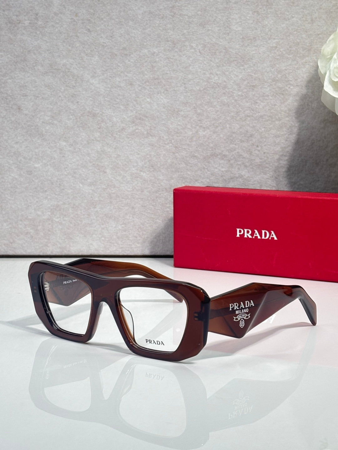 Prada dark brown rectangular eyeglasses with clear lenses and tortoise accents