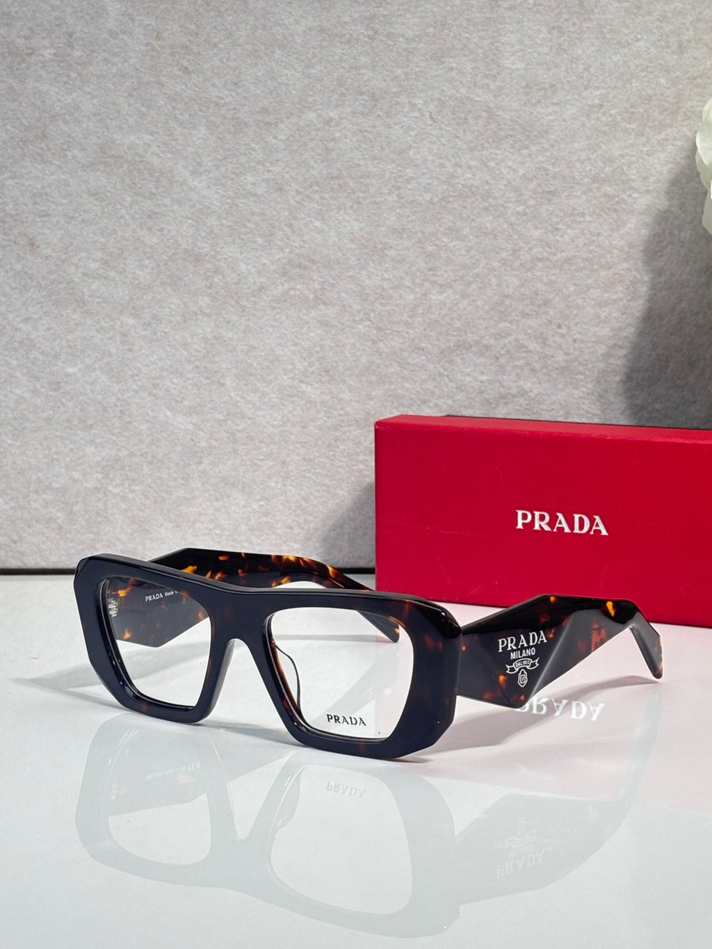 Prada black rectangular eyeglasses with clear lenses and dark temples