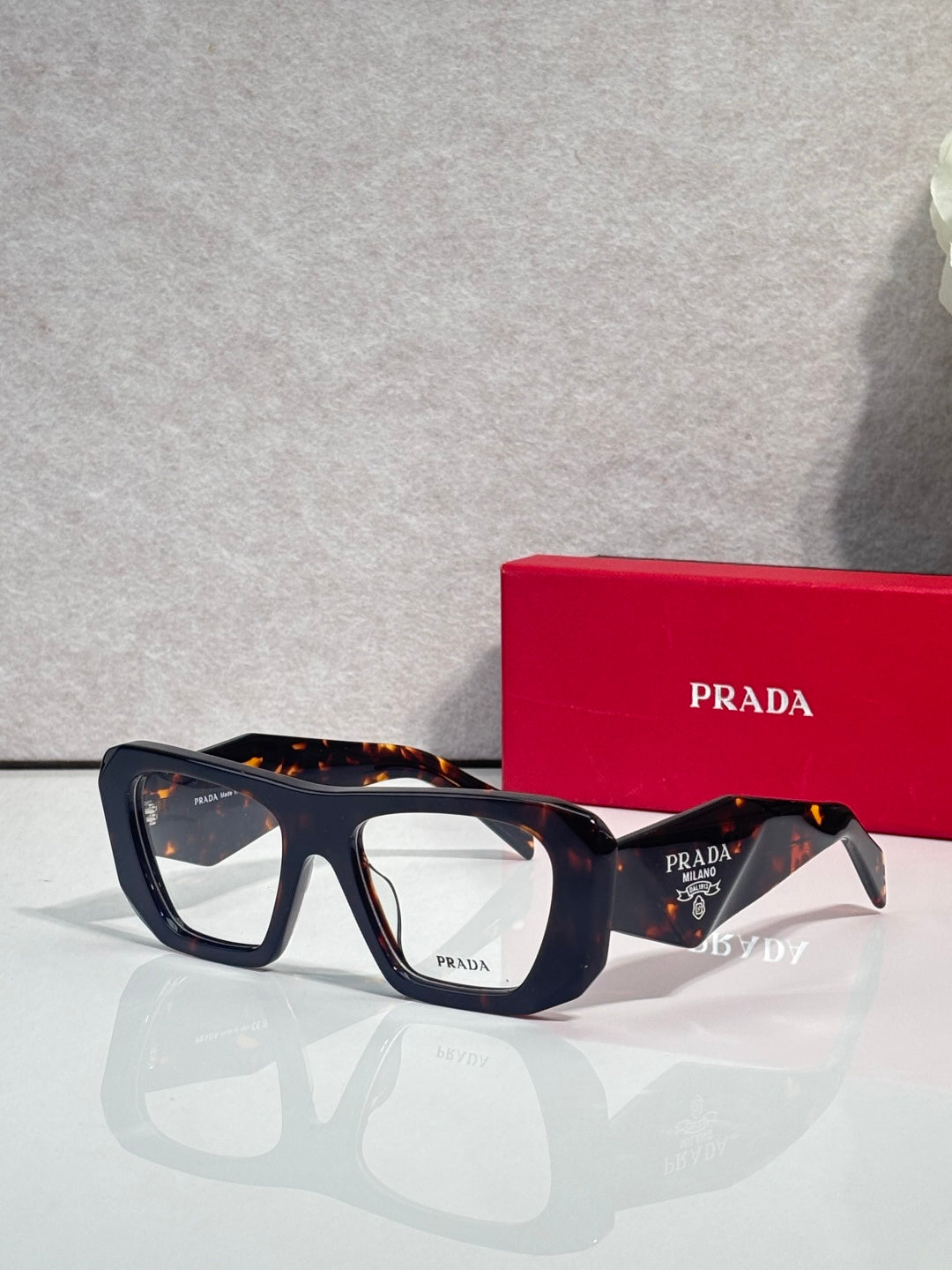 Prada black rectangular eyeglasses with clear lenses and dark temples